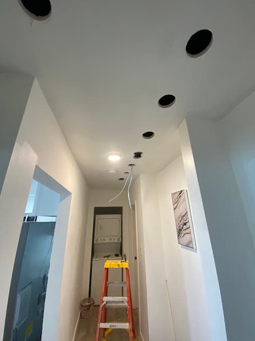 Recessed lighting install in progress in a hallway